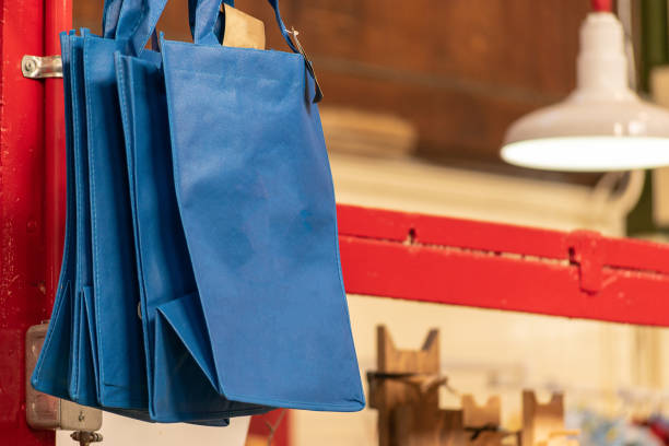 Blue foldable reusable shopping bags for sale at a Market.